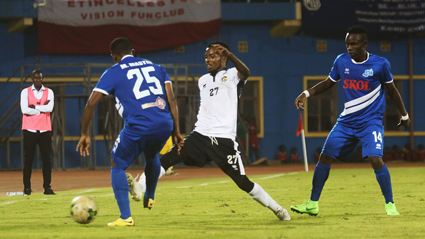 Goal-scorer Dominique Savio Nshuti (middle) vies for the ball with Rayon Sportsu2019 defender Francois u2018Masteru2019 Mugisha (left) in the first-half during APRu2019s 1-0 victory over the Blues at Amahoro Stadium on Friday. Samuel Ngendahimana.