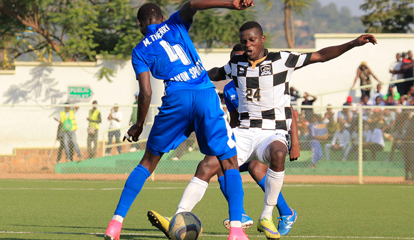 Emmanuel Imanishimwe (#24) vies for the ball with Rayon Sports skipper Thierry Manzi during a past league match at Kigali Stadium. Sam Ngendahimana.