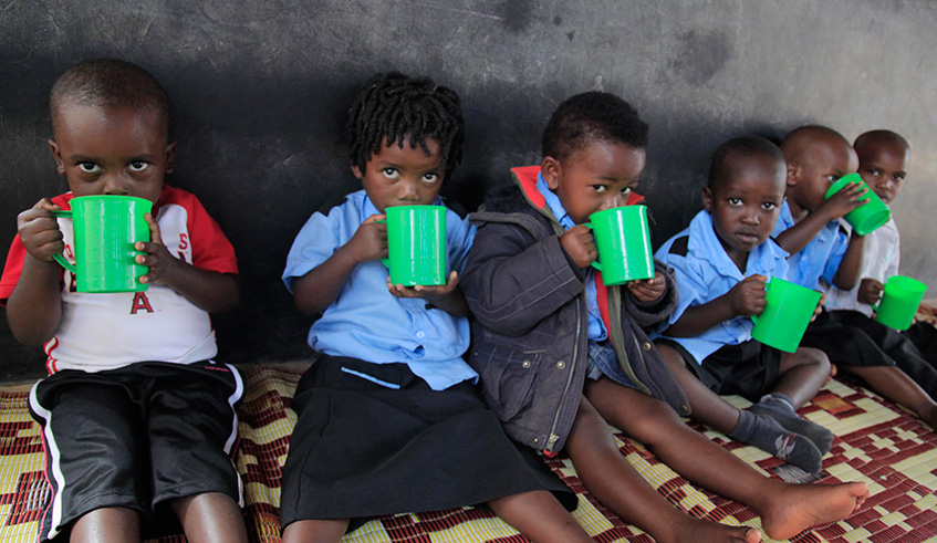 Children take porridge in Mageragere Sector. Sam Ngendahimana.