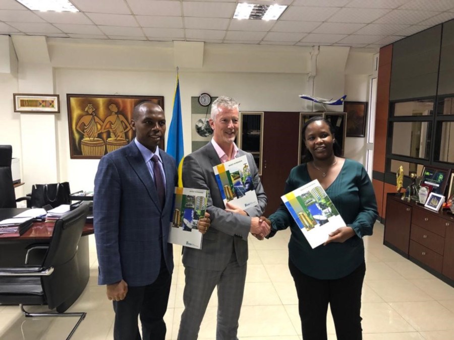 L-R: RMB CEO, Dr. Francis Gatare, Gasmeth CEO, Stephen Tierney and RDB CEO, Ms. Clare Akamanzi pose with Invest in Rwanda booklets after signing the methane gas extraction agreement at RDB office.