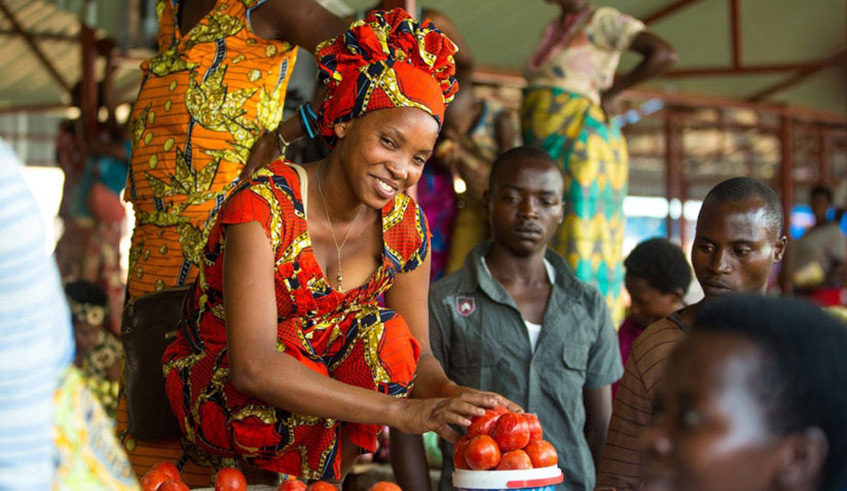 A lady at her fruit and vegetable stall in a Kigali market. File photo