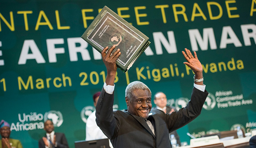 African Union Commission Chairperson Moussa Faki displays a copy of the AfCTA after its signing in Kigali in March 2018. African Continental Free Trade Area is expected  to formally launch operations in July this year. So far 18 countries have ratified the agreement. File.
