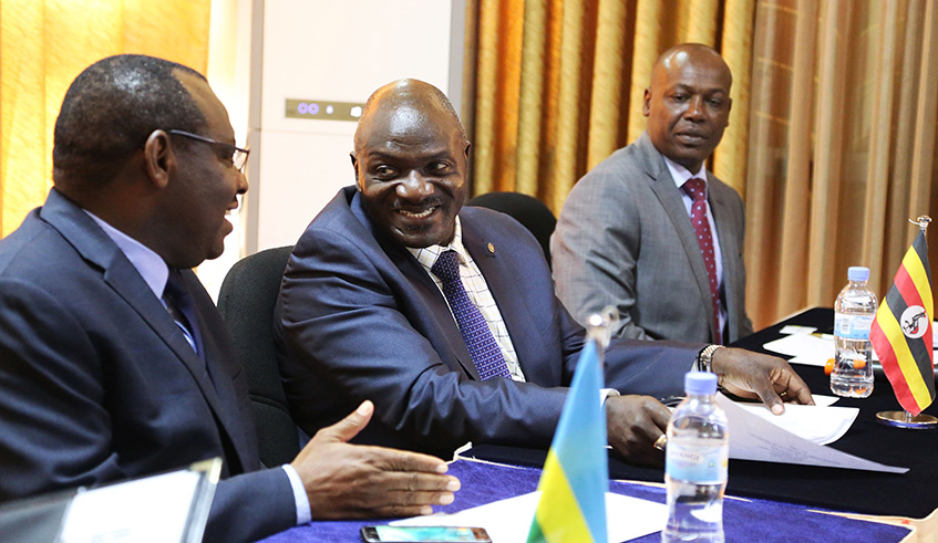 The Minister for infrastructure, Claver Gatete, interacts with Head of Ugandan delegation Edward Katumba Wamala as  James Macharia, from Kenya, looks on during the meeting on Northern Corridor in Kigali last week. Courtesy.