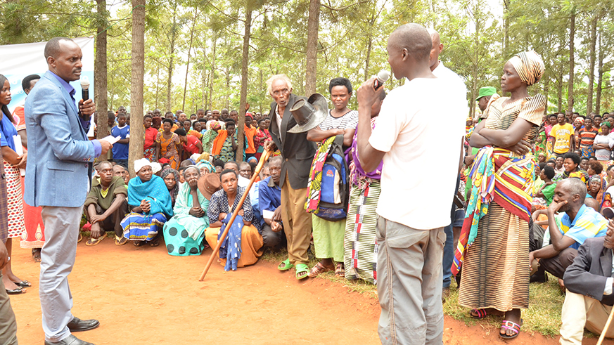 Eastern Province Governor Fred Mufulukye (left) listens as residents of Rwankuba in Murambi Sector, Gatsibo District, tell him how they have been denied services at health centre because their money was stolen by an agent who collected it. Jean de Dieu Nsabimana.