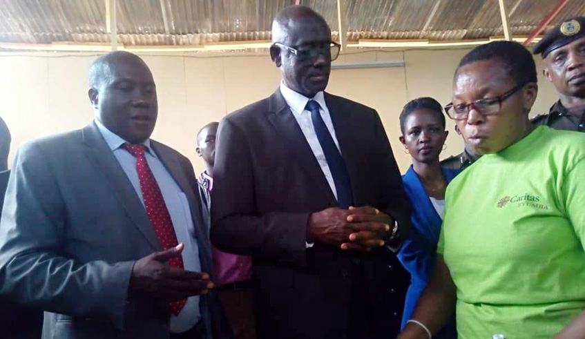 Busingye (2nd left) listens to an inmate at Musanze Prison during the launch of a project that seeks to economically empower women and juvenile inmates. Regis Umurengezi.