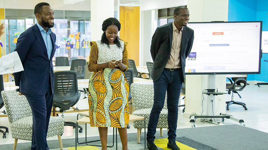 Minister for ICT & Innovation Paula Ingabire (centre) launches the African u2018Design Labu2019 with a tweet from her phone on Thursday. Looking on are tech-prenuers Bosun Tijani (left), the founder of Co-Creation Hub (CcHub) and Femi Longe (R) the co-founder and head of innovation. Rwanda is the firmu2019s first operation outside Nigeria.  Emmanuel Kwizera.