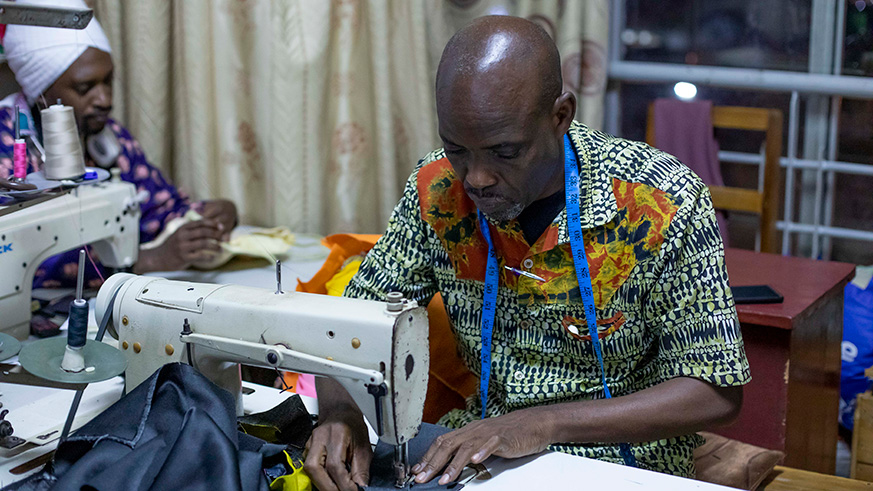 Emmanuel Ngoye working at his tailor shop in the city center. He has designed costumes for some of the biggest movies shot in Rwanda. Emmanuel Kwizera.