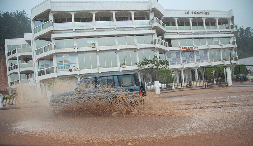 A vehicle is covered in raiwater during a heavy downpour at Rwandex, Kigali last year. Emmanuel Kwizera.