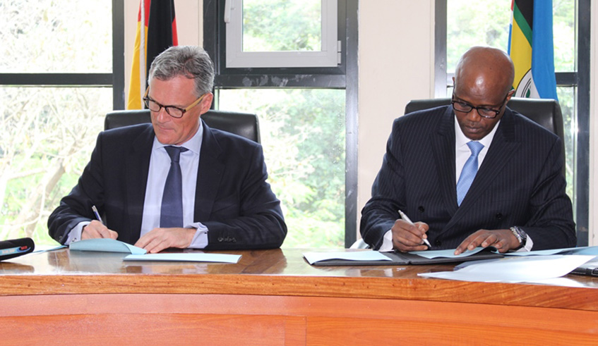 EAC Secretary General Libu00e9rat Mfumukeko (right) and the German Ambassador to the EAC, Dr Detlef Wu00e4chter, sign the agreement. Courtesy.