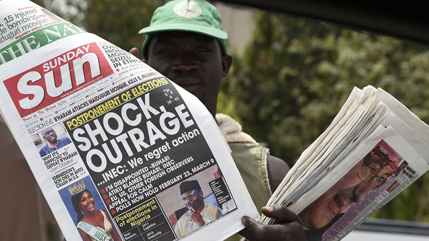 A newspaper vendor on the streets of Nigeria. Net photo.