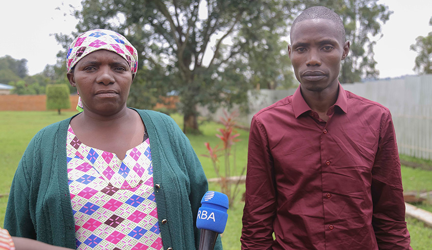 Marguerite Mukanyarwaya with her son Damascene Muhawenimana speaking to journalists yesterday. Emmanuel Kwizera