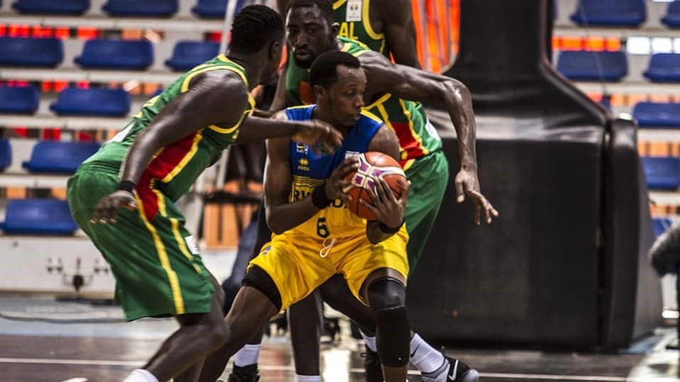 Rwanda's Steven Havugintwari (with the ball) tries to overcome challenge from two Senegal players during Friday's 84-41 defeat in Abidjan, Ivory Coast. Courtesy