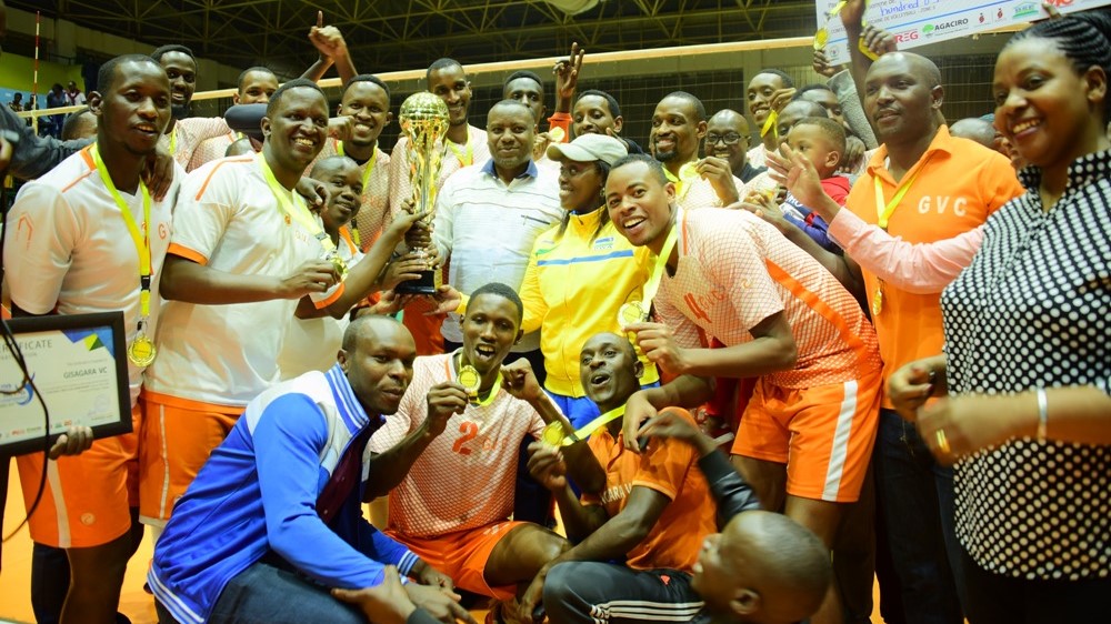 Gisagara volleyball club players and staff celebrate with medals and the trophy after beating REG in the final of the inaugural regional competition at Amahoro Stadium on Saturday. Courtesy