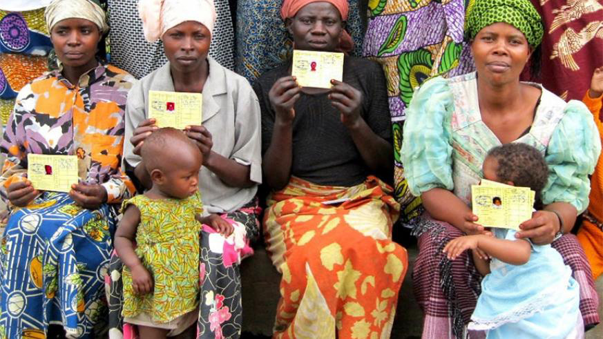 Mothers pose in a group photo with their Mutuelle de Sante cards. File