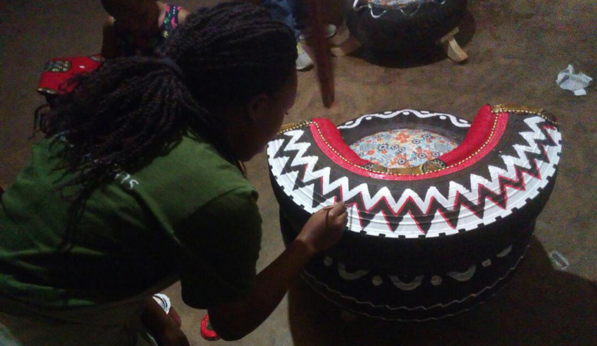 Rwibutso while painting a chair. Photos by Joan Mbabazi.