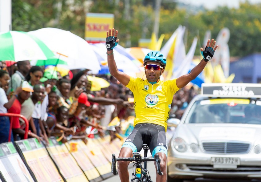 Merhawi Kudus throws his arms in the air to celebrate his second stage victory this year after his solo finish during Stage 3 in Rubavu District on Tuesday