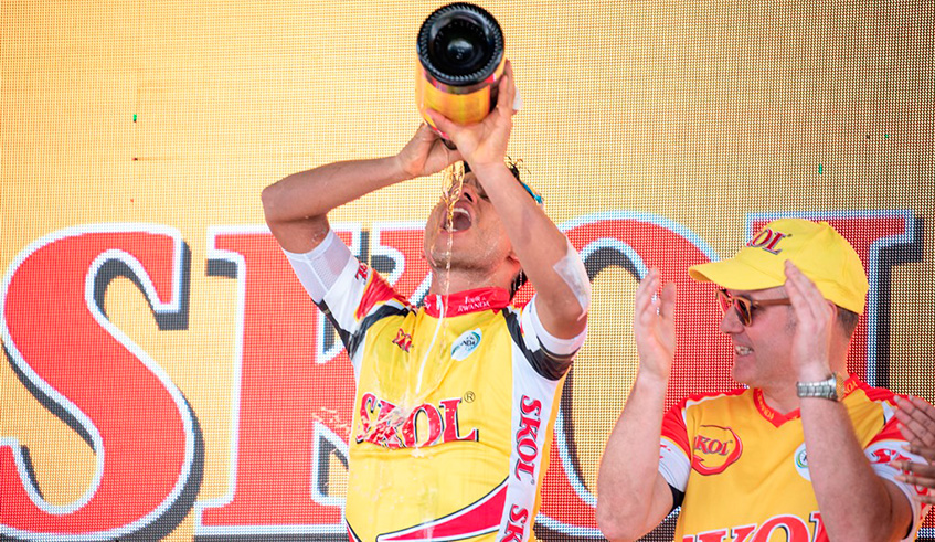 Israel Cycling Academy's Edwin Avila Vanegas sips Skol champagne in celebration of his Stage 4 victory.