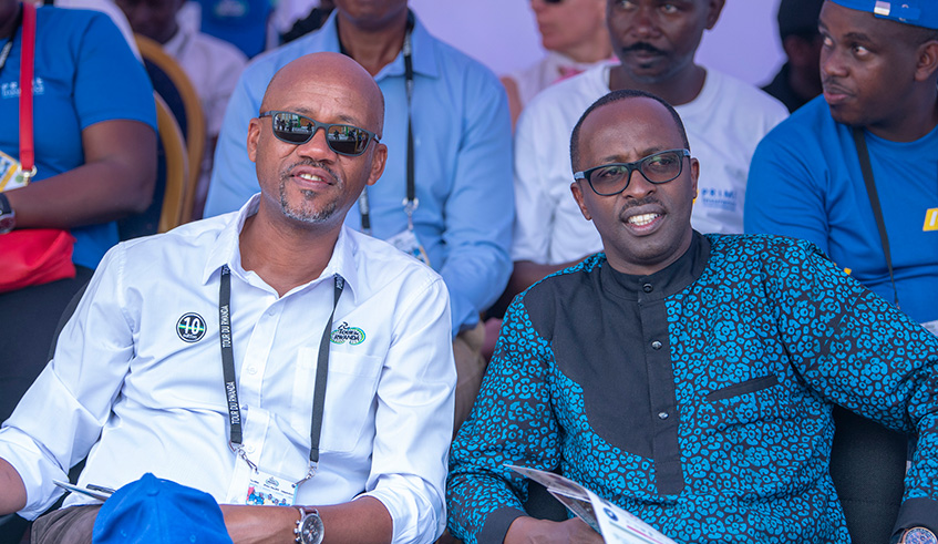 Rwanda Cycling Federation boss, Aimable Bayingana (L), and the Governor of West Province Alphonse Munyantwali enjoy the finish-line sprints during Stage 4 in Karongi on Wednesday.