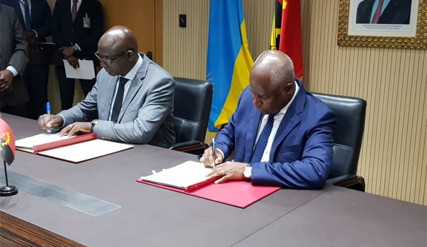 Minister Busingye (L) and his Angolan counterpart Angelo de Barros da Veiga Tavares during the signing in Luanda, Angola. Courtesy