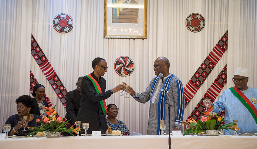 President Kagame shares a toast with his host, President Roch-Marc Christian Kaboru00e9 of Burkina Faso (centre), as President Ibrahim Boubacar Keu00efta of Mali (right) looks on. Both Presidents Kagame and Keu00efta were awarded with the u2018Grand Croix de lu2019Etalonu2019 medal by their host during a dinner hosted in their honour. Kagame is in the West African country for the Pan-African Film and Television Festival. Village Urugwiro.