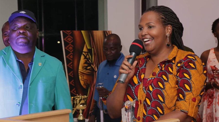 Nadege Nyahwihwiri during her acceptance speech on Saturday night after receiving her trophy at Kigali Golf Club. On the left is Davis Kashaka, the Kigali Golf Club captain. / Courtesy