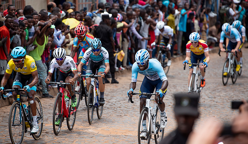 Merhawi Kudus (in yellow) leads a chasing group at the notorious cobbled Wall of Kigali as thousands of fans cheered on the riders during the eighth and final stage of the 2019 Tour du Rwanda on Sunday. Plaisir Muzogeye.