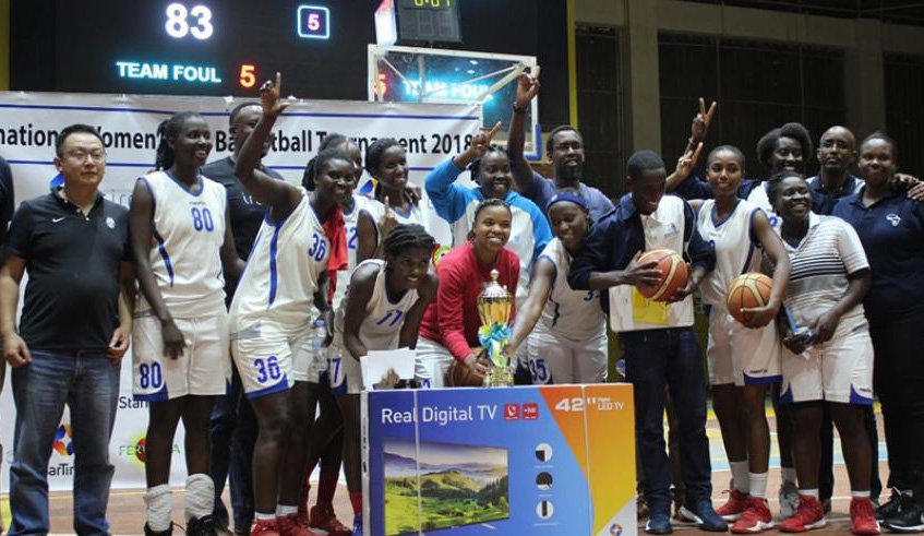IPRC-South players and staff celebrate with the trophy after overcoming APR to win the tournamentu2019s 2018 edition at Amahoro Indoor Stadium. File.