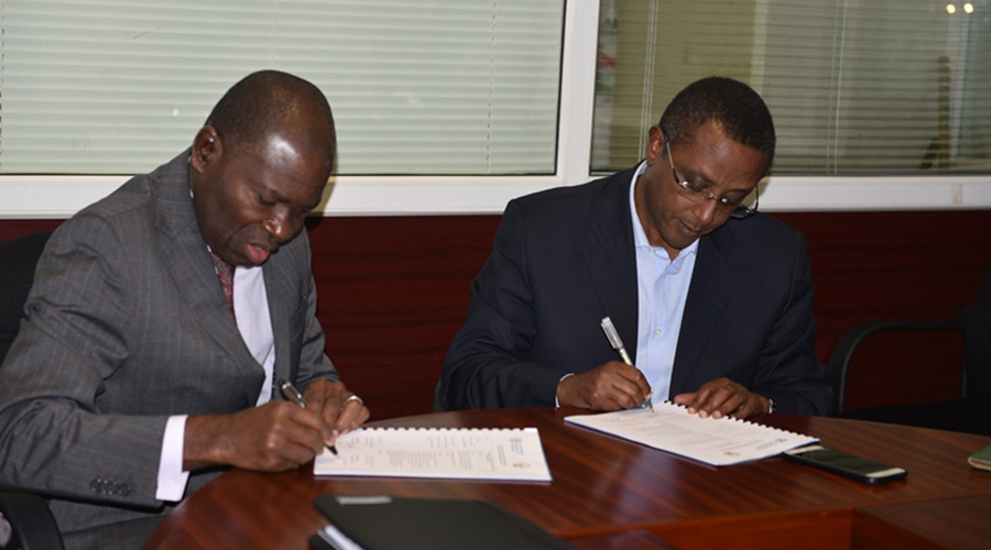 Dr Gualbert Gbehounou, the FAO Representative to Rwanda  and Minister Vincent Biruta signing the partnership last week. / Michel Nkurunziza