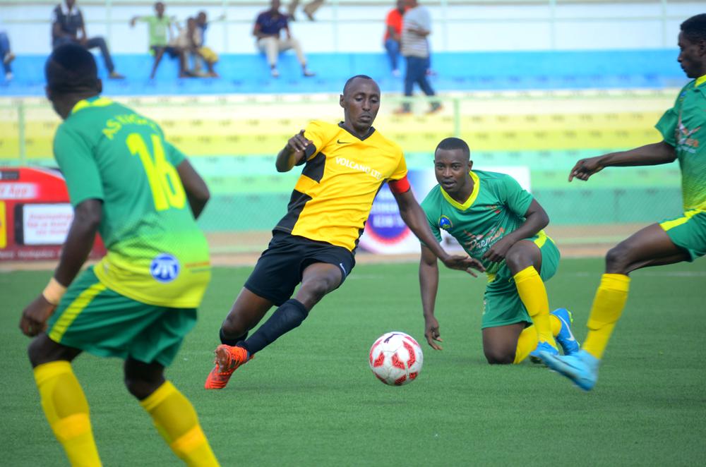 Mukura forward Christopher Ndayishimiye challenges AS Kigali players for the ball during the 2018 Peace Cupu2019s round of 16 at Kigali Stadium. / Courtesy