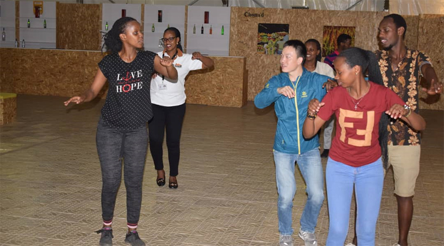 A group of budding dancers getting some dancing tips during a session at Ganza Fitness traditional dance class at Kigali Culture Village.