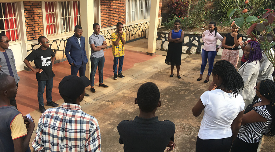 A group of youth stands in a cycle to share their opinions on the issue of gender equality, at Mfura Arts Kimironko, on International Womenu2019s Day. / Mary Ingabire