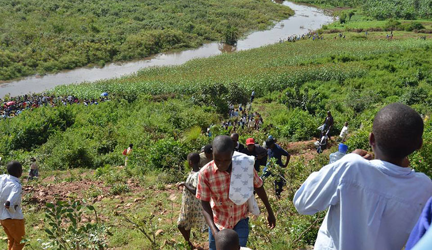 Mourners during a commemorators activity at the part of the swamp where thousands of Tutsi were killed during the Genocide between April and May 1994. Kelly Rwamapera.