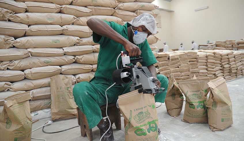 A worker packages cassava flour at Kinazi Cassava Plant in Ruhango District. The plant is set to receive a bailout from government as it desperately seeks to turn around its unprofitable business operations. File.
