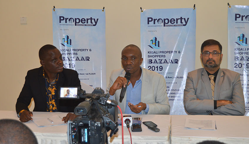 Fred Oluoch-Ojiwah (C) editor of Property Magazine Rwanda speaks during a press conference as RG Consult's Remmy Lubega (L) looks on. (Courtesy)