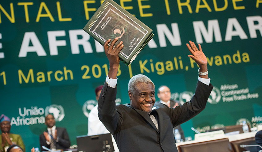  African Union Commission chairperson Moussa Faki Mahamat celebrates the signing of the African Continental Free Trade Area deal in Rwandan capital of Kigali in March 2018. About 50 counties have since signed the deal, while 18 have  ratified it. File.