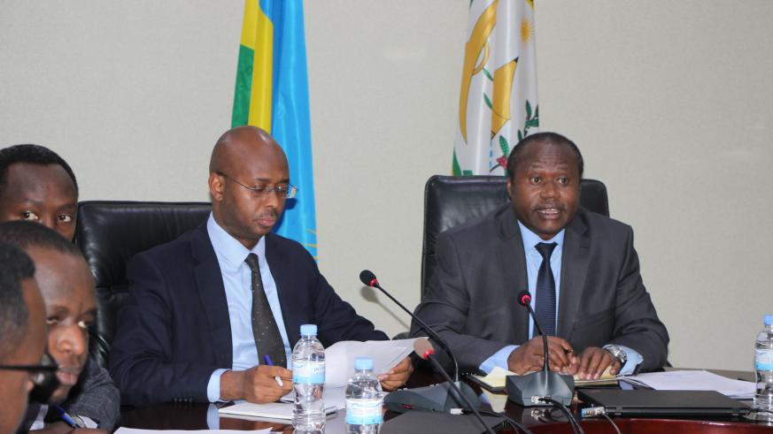 Dr Uzziel Ndagijimana, Minister of Finance and Economic Planning (R) explains how Rwandau2019s economy grew by 8.6 per cent in 2018 as the Director General of the National Institute of Statistics of Rwanda, Yusuf Murangwa (L) looking on. / Courtesy