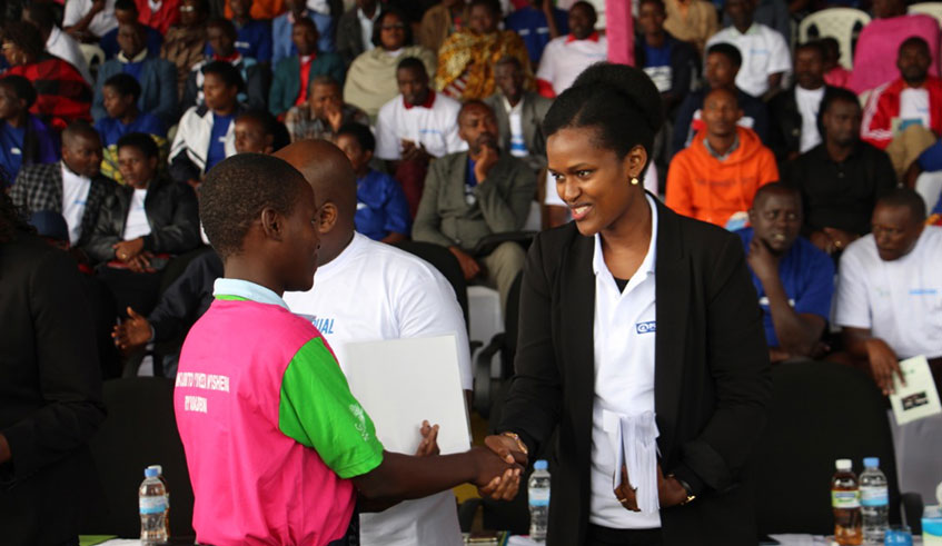 The Director General of Imbuto Foundation, Sandrine Umutoni congratulates one of the best performers.