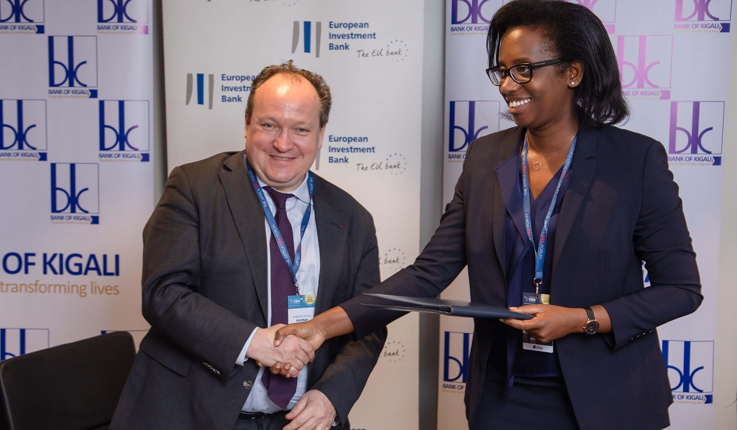Dr. Diane Karusisi, the Chief Executive Officer of Bank of Kigali with Ambroise Fayolle, the Vice President of the European Investment Bank exchange documents after the signing ceremony on March 25, 2019 at Kigal. Emmanuel Kwizera.