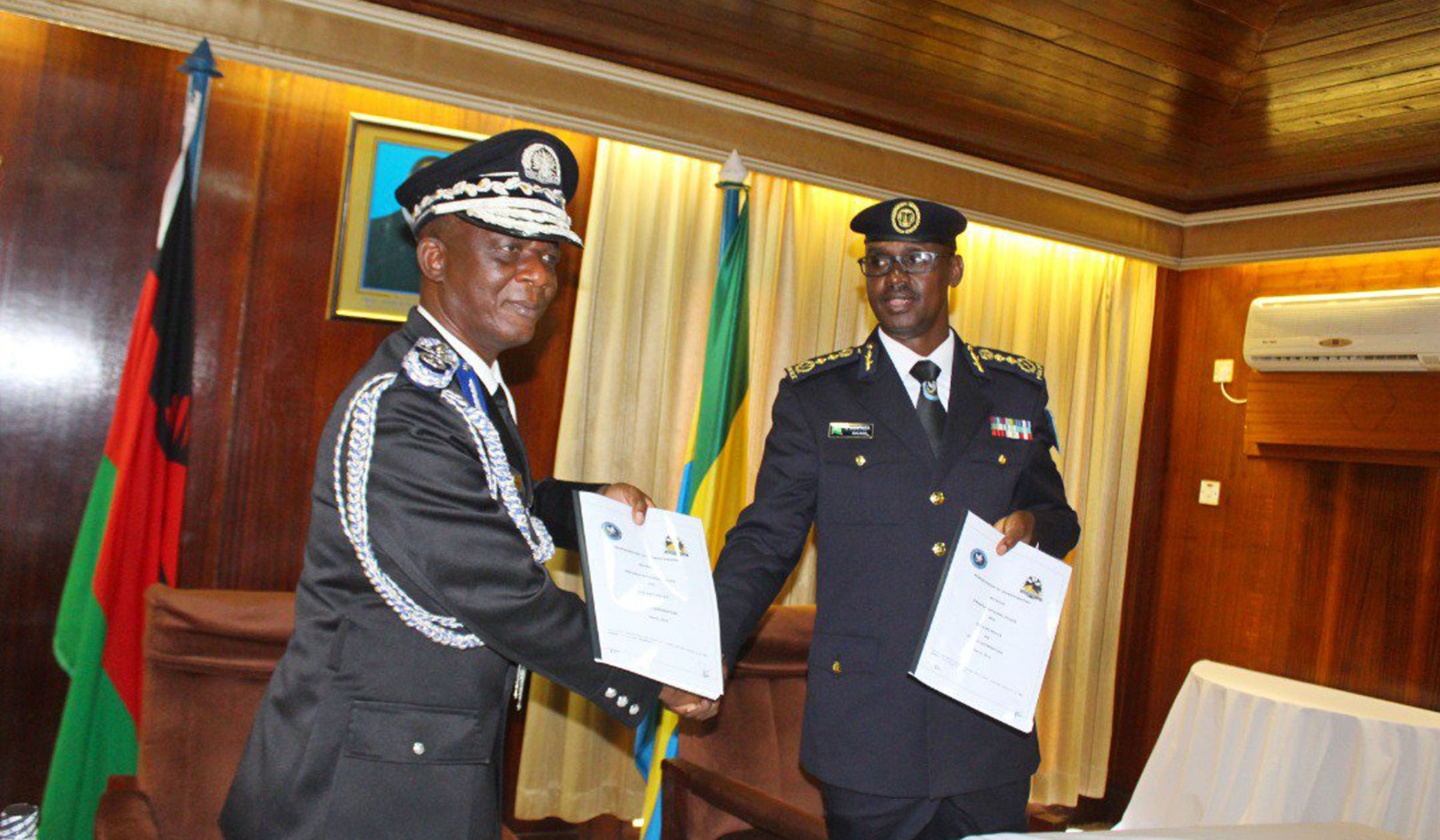 IGP Dan Munyuza with his Malawian counterpart Rodney Jose (left) exchange documents after the signing ceremony on March 26, 2019 in Lilongwe. Courtesy.