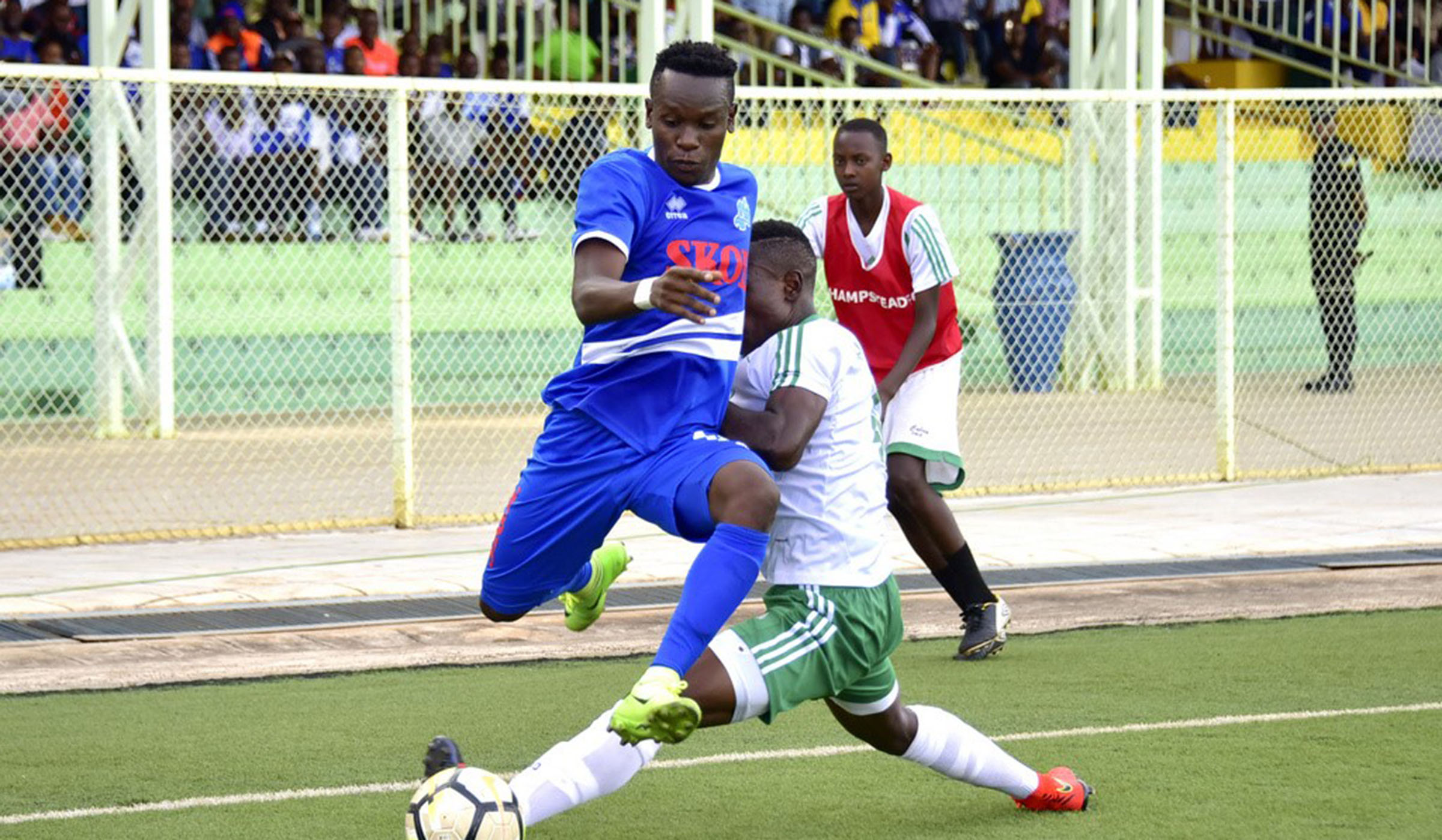 Rayon Sports full-back Eric u2018Raduu2019 Iradukunda escapes a tackle from SC Kiyovu opponent during the first-leg at Kigali Stadium, which ended 2-1 in favour of SC Kiyovu courtesy of Djuma Nizeyimanau2019s brace. Courtesy.