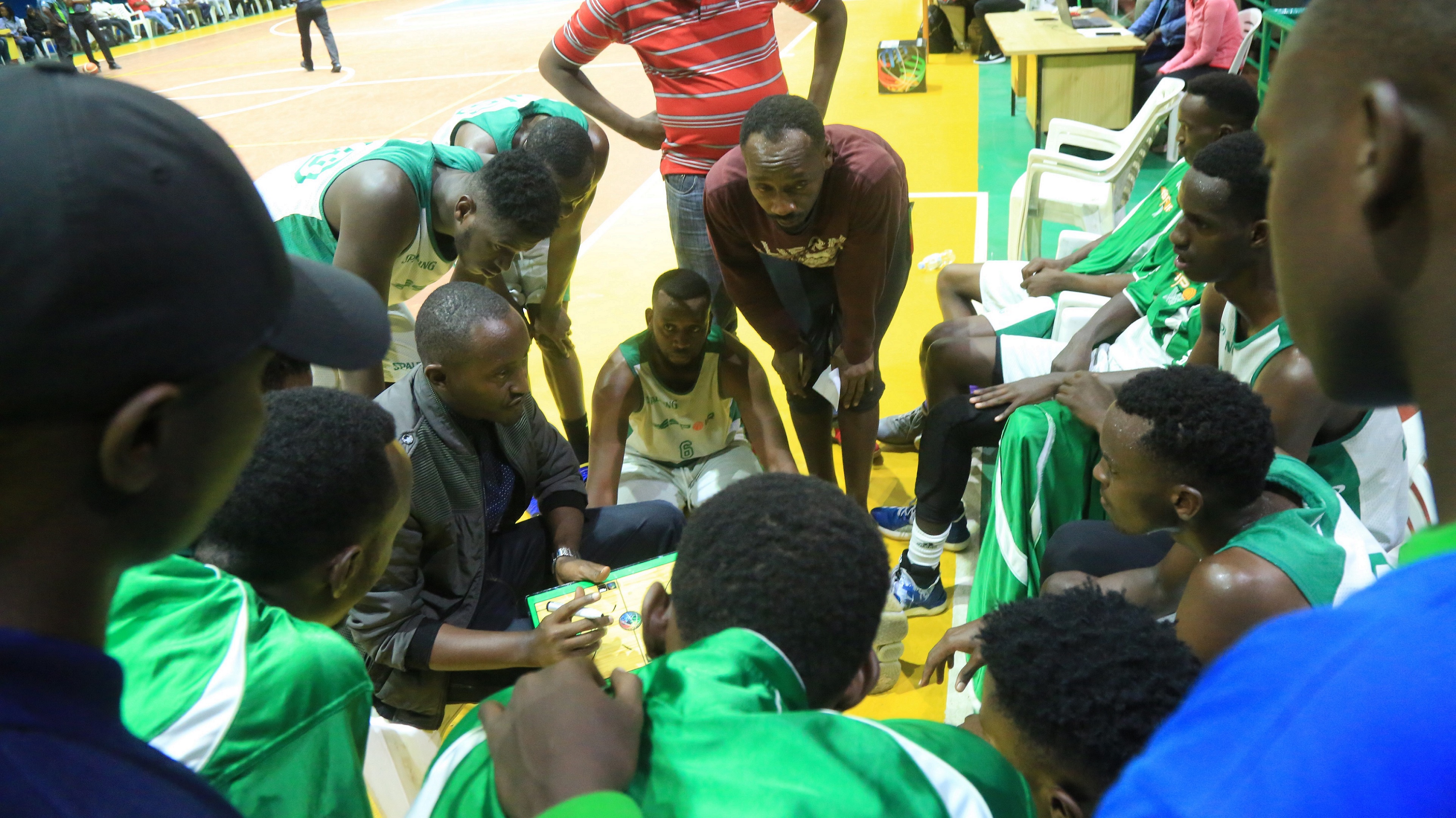 Espoir Basketball Club players, who face Patriots on Friday night, are seen here being briefed by head coach Maxime Mwiseneza during a past league game against APR at Amahoro Stadium. Sam Ngendahimana
