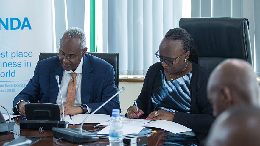 Aboubaker Omar Hadi, the Chairman of Djibouti Ports and Free Zones Authority and Jeanne Isabelle Gasana, the Managing Director of Prime Economic Zones sign a partnership agreement to launch a joint venture which will develop Djiboutiu2019s land in Rwanda yesterday at RDB. Nadege Imbabazi.