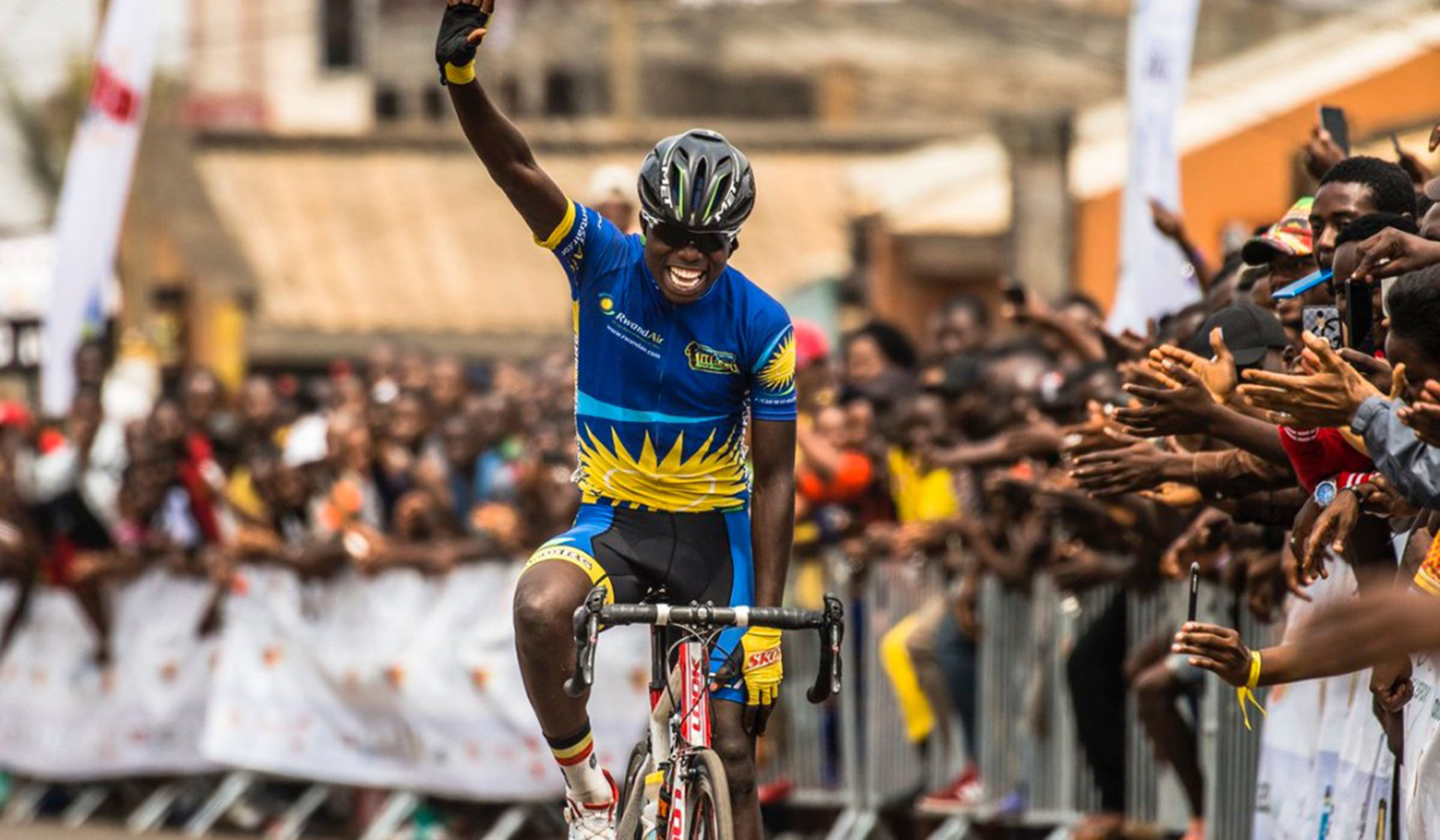 Moise Mugisha celebrates his solo finish after winnig the fifth and final stage of the 2019 Tour de lu2019Espoir in Yaoundu00e9, Cameroun in February. File.