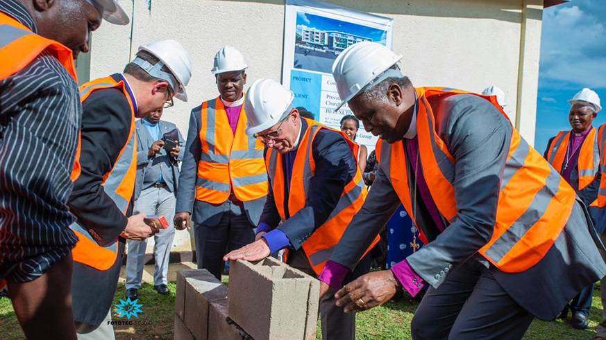 Archbishop Laurent Mbanda (right) and other officials lay a foundation stone to launch the construction activities of a commercial building of the Anglican Church. Courtesy.