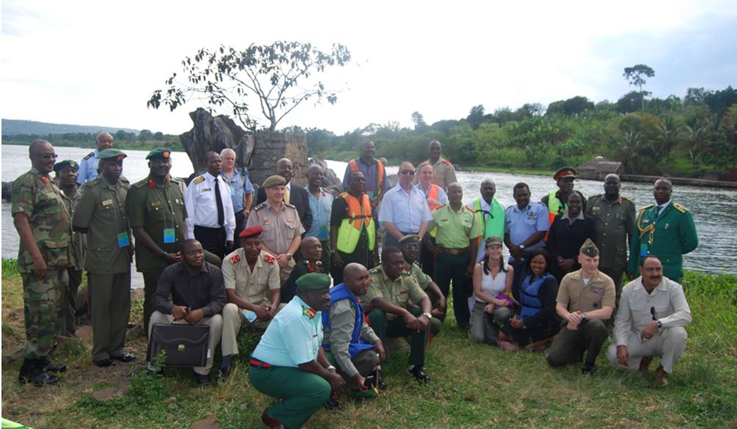 In this 2010 photo from an excursion of the River Nile in Uganda, the author is seated left with a briefcase; standing right behind him is Col. Stephen Oluka; while Col. Kasiita is 2nd left, third row; with Gen Gutti standing in the 2nd row, second right. / Courtesy