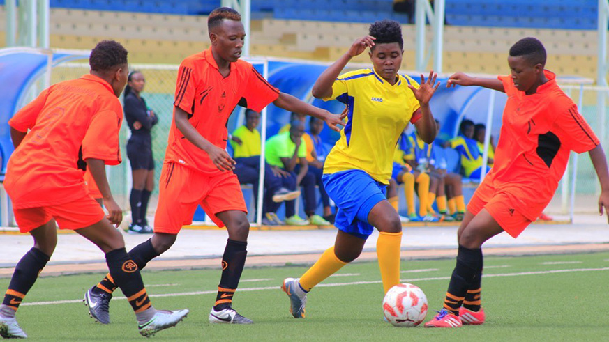 Scandinavia women football club players battle for the ball with AS Kigali skipper Alice Kalimba during the Heroes Cup title match at Kigali Stadium in January. Courtesy.