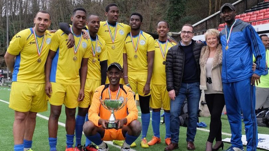 Eric Eugene Murangwa (with a trophy), who was Rayon Sports goalkeeper at the time of the Genocide, is seen with his UK-based Rwandan Diaspora team after beating their Syrian counterparts in a past charity match in London. Net Photos.