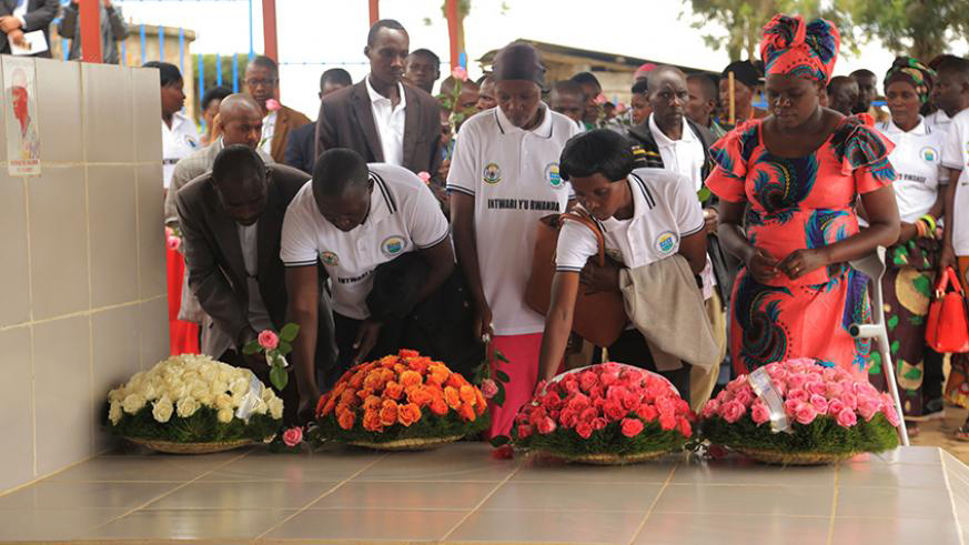 Some of the heroes from ES Nyange lay wreaths on the grave of Valens Ndemeye in honour of his memory, last year. Photos by Sam Ngendahimana.
