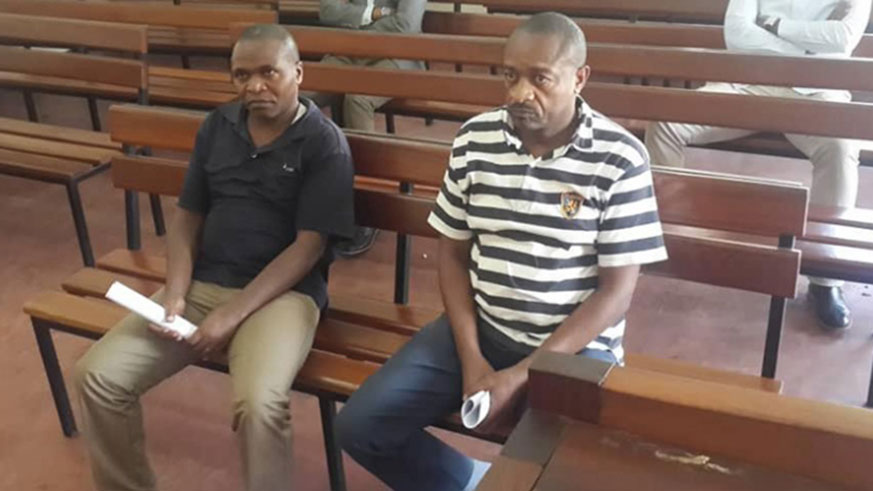 Nkaka (in striped shirt) and Nsekanabo in court yesterday. The two were arrested at the Uganda-DRC border late last year. / James Karuhanga