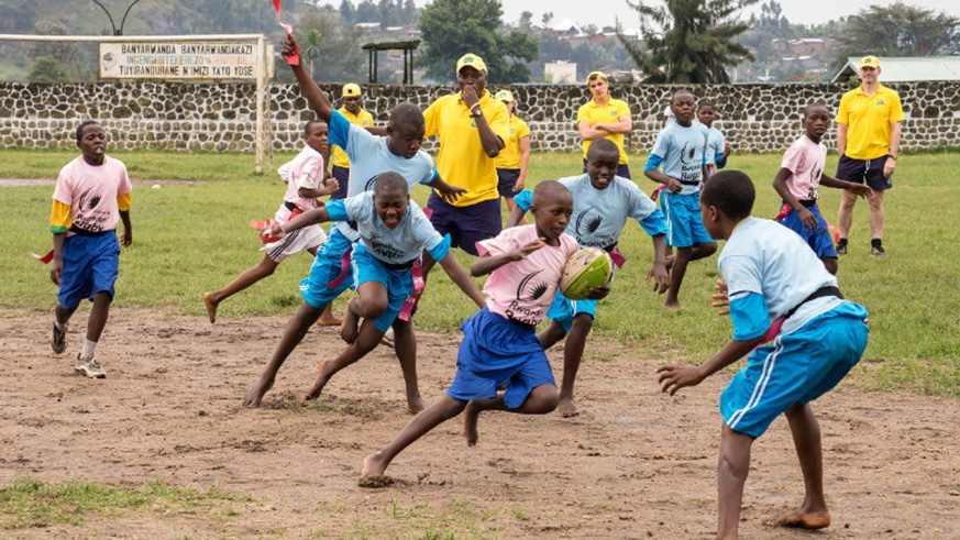 Tharcisse Kamanda (blowing the whistle), seen here training school children, is as one of the local rugby pioneers and has been part of the sport since 2001. File